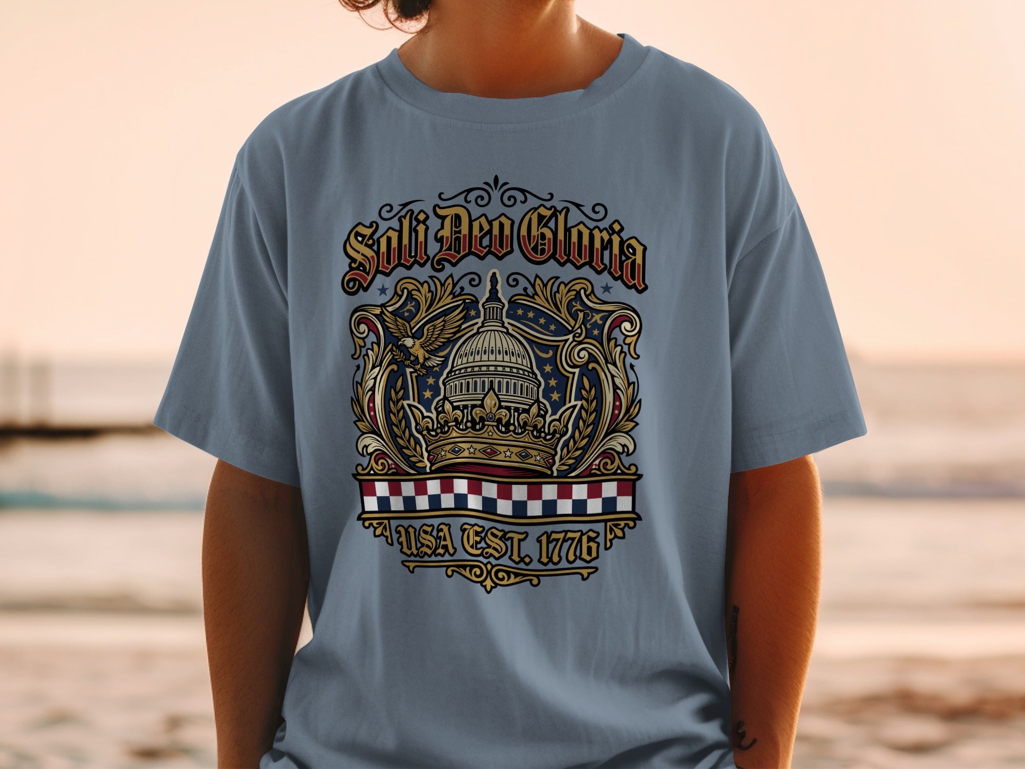 Blue t-shirt with "Soli Deo Gloria USA Est 1776" and eagle/Capitol dome emblem.