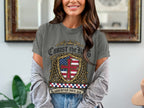 Grey t-shirt with a crest featuring a cross and American flag, reading "Christ the King".