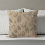 Beige throw pillow with a repeating pattern of golden and green botanical elements.