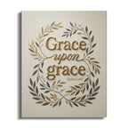 "Grace upon grace" text in ornate gold and olive branches on canvas.