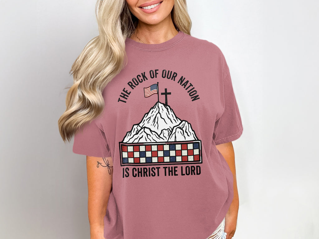 T-shirt with a mountain landscape, American flag, cross, and checkered border.