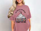 T-shirt with a mountain landscape, American flag, cross, and checkered border.