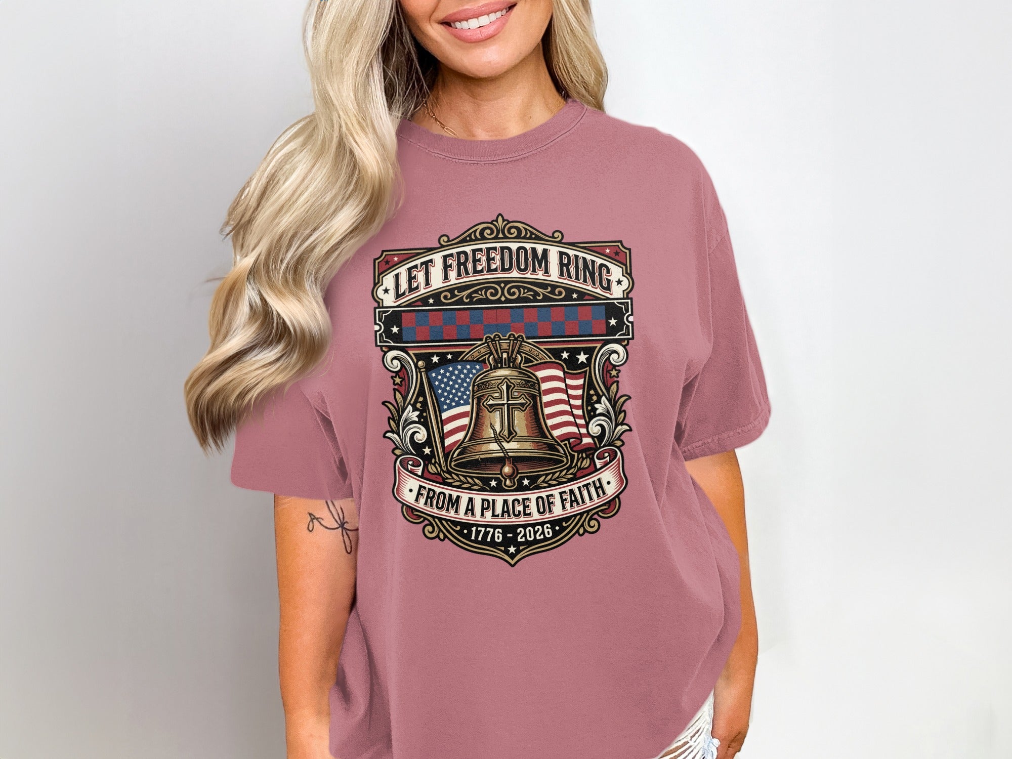 T-shirt with bell, flag, and "Let Freedom Ring from a Place of Faith" text.