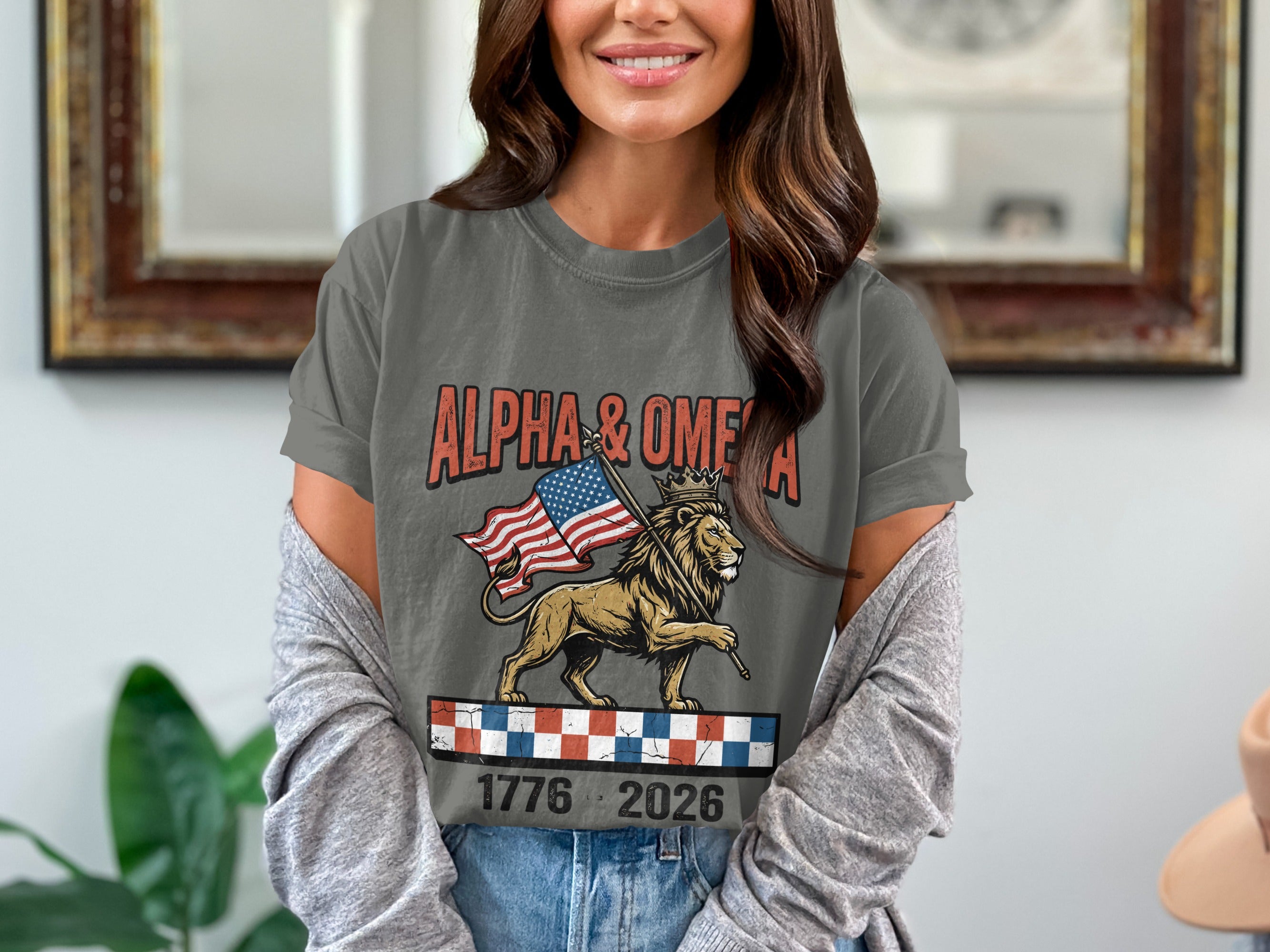 Grey t-shirt with lion holding flag, "ALPHA & OMEGA" and dates.