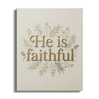 "He is faithful" text surrounded by delicate floral branches on a beige linen background.