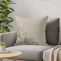 Light beige throw pillow with a delicate botanical design in the corner.