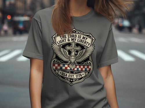 Grey t-shirt with shield, eagle, and text "The Lord is my light & my liberty USA Est. 1776".