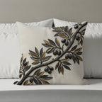 Textured cream pillow with raised dark olive branch and olives.