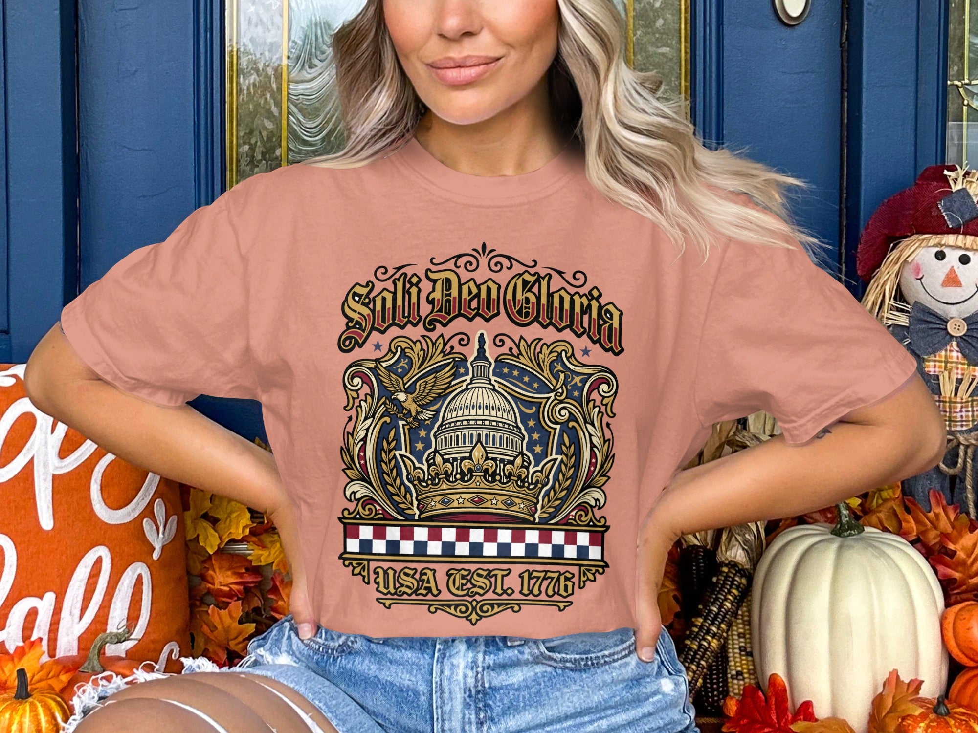 "USA Est. 1776" text on a woman wearing a distressed graphic tee.