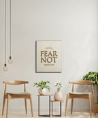 "Fear Not" wall art with Isaiah 41:10 text above two chairs and tables.