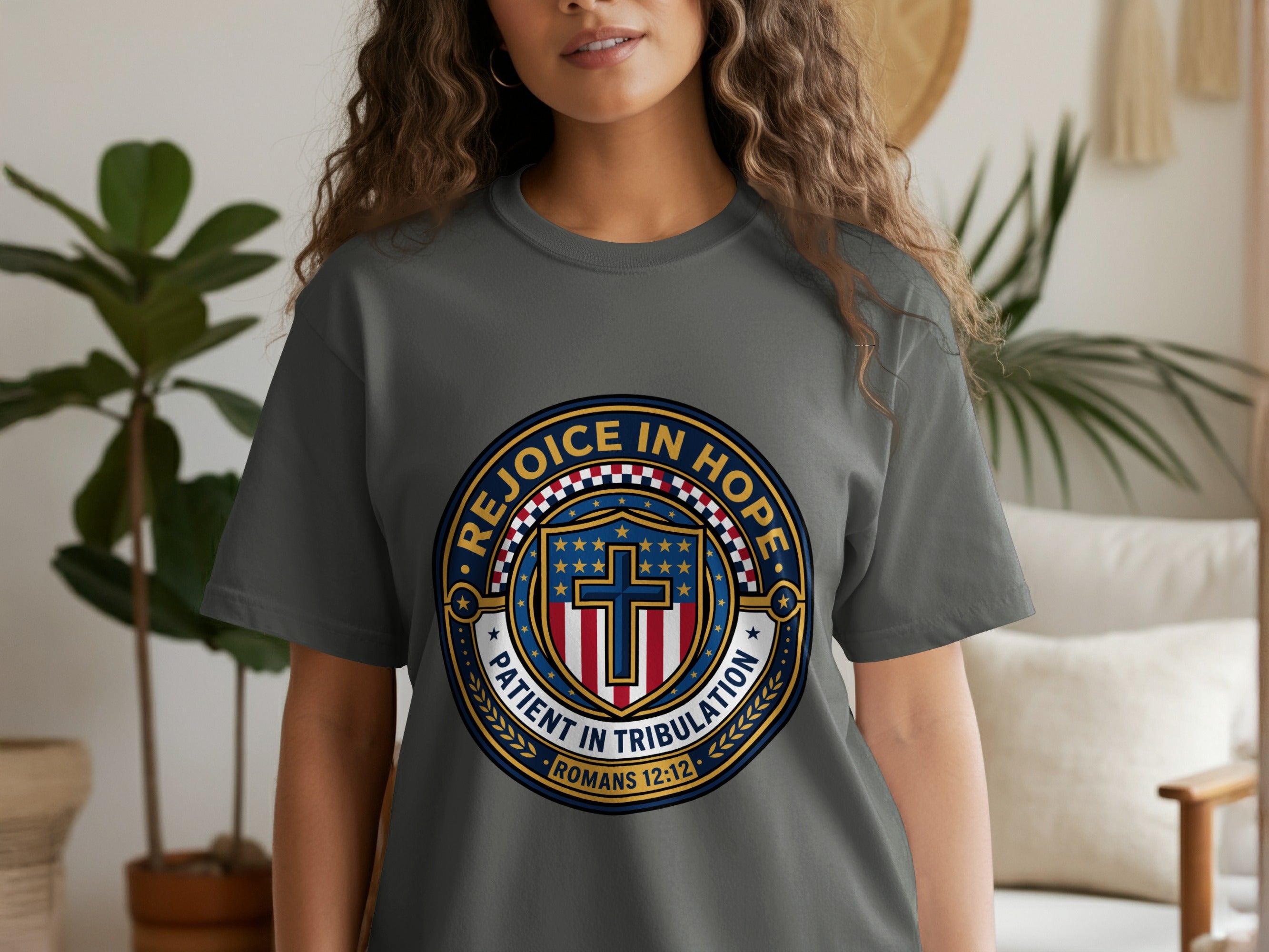 Grey t-shirt with circular graphic featuring stars, stripes, and "Rejoice in Hope Patient in Tribulation."