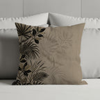 Square throw pillow with a tan background and a dark botanical print on the left.
