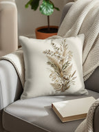 Neutral-toned throw pillow with dried botanical arrangement on a grey chair.