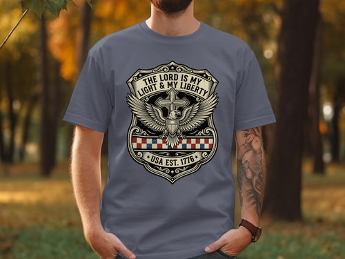 Grey t-shirt with shield graphic: "The Lord is My Light & My Liberty USA Est. 1776".