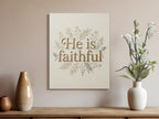 Canvas art with "He is faithful" text inside a floral wreath.
