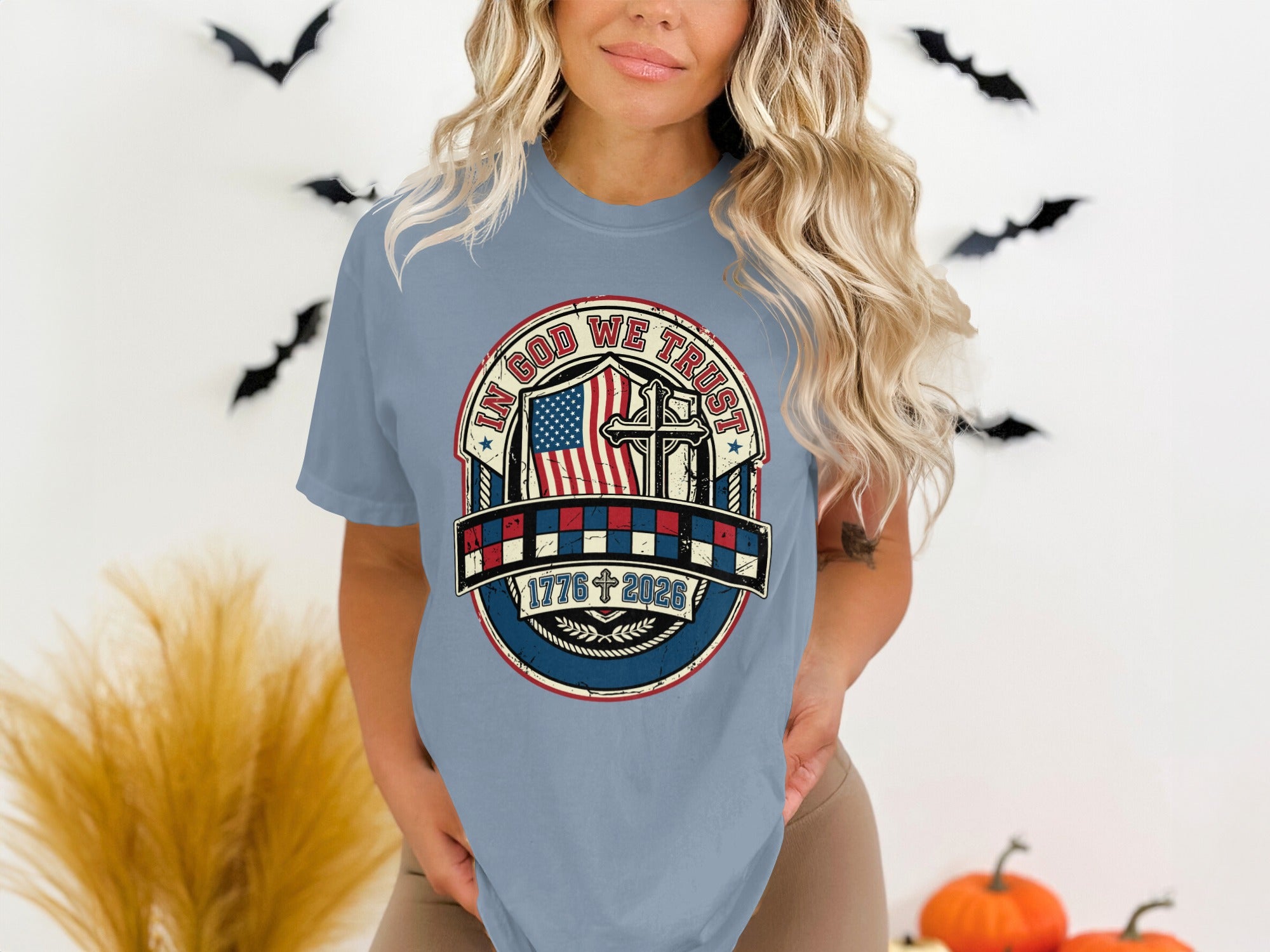 T-shirt with "In God We Trust" text, American flag, and 1776-2026 dates.