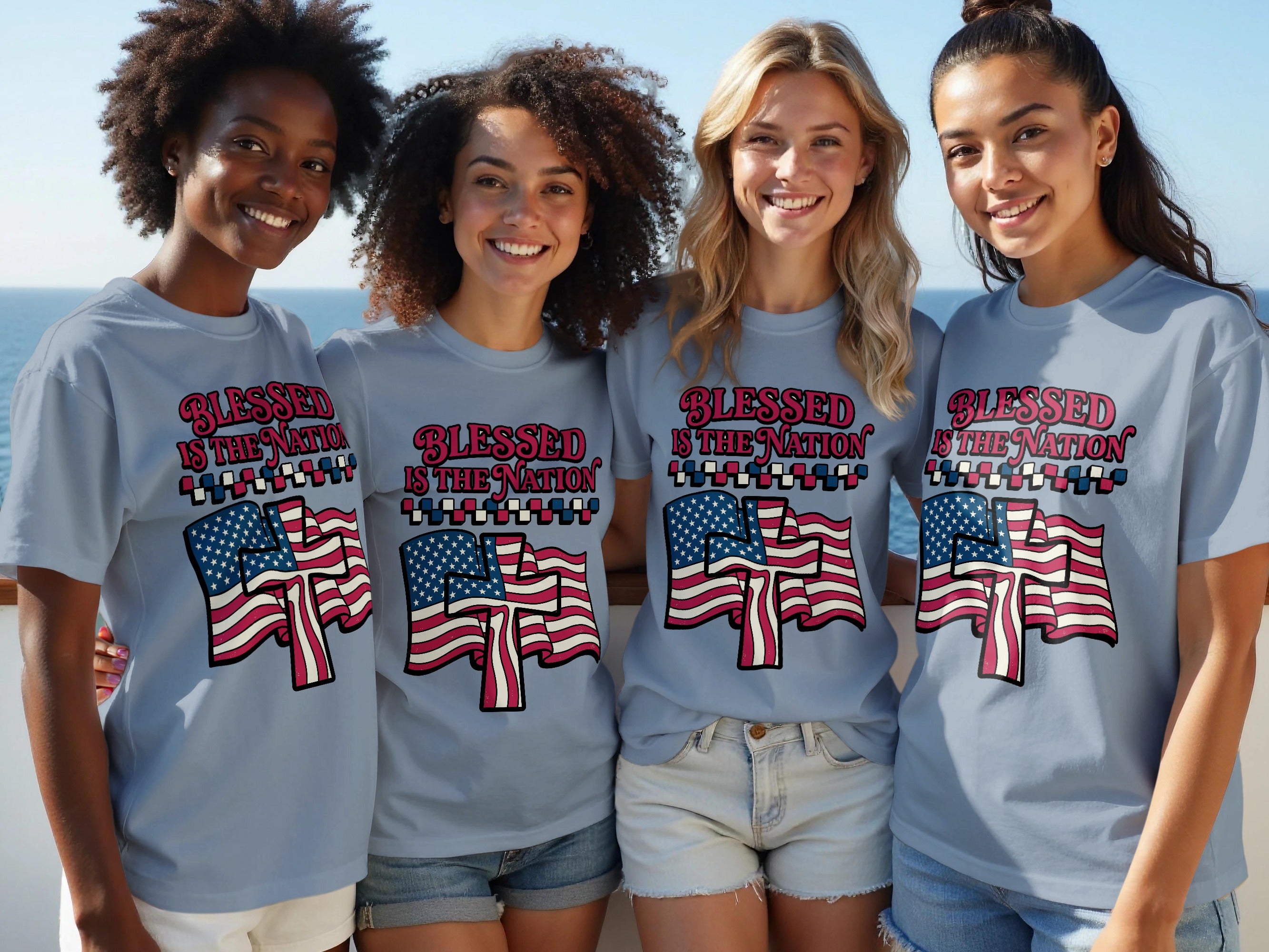 Four smiling women wearing t-shirts with "BLESSED IS THE NATION" and American flags.