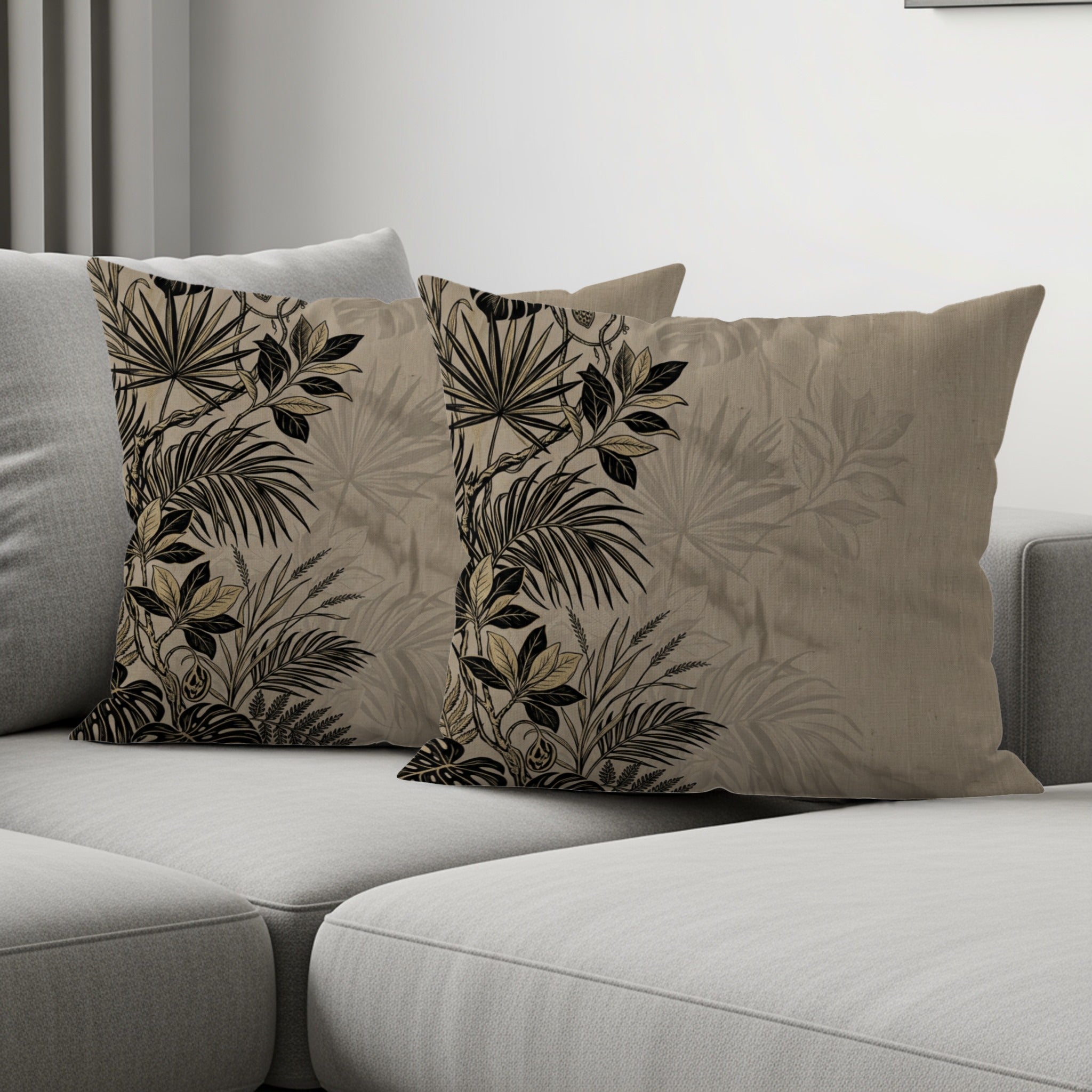 Two throw pillows with a tropical botanical print on a gray sofa.