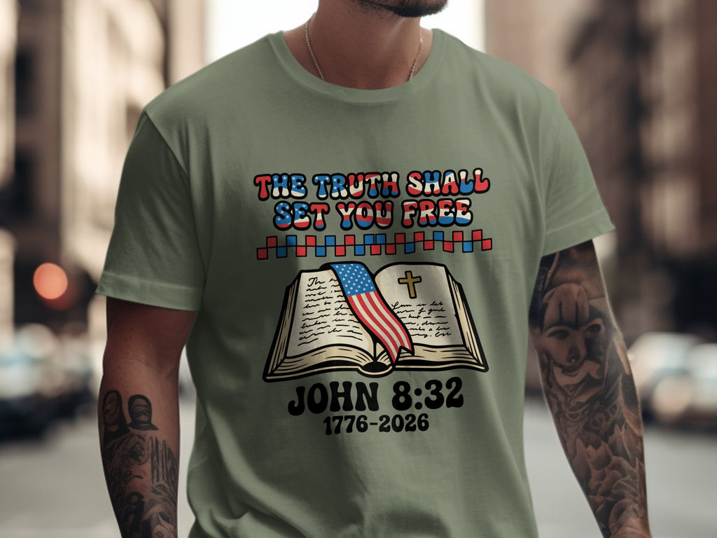 Green t-shirt with book, flag, and "THE TRUTH SHALL SET YOU FREE JOHN 8:32 1776-2026"