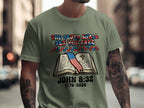 Green t-shirt with book, flag, and "THE TRUTH SHALL SET YOU FREE JOHN 8:32 1776-2026"