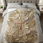 Embossed cross with doves and leaves on a neutral blanket.