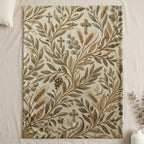 Tan and gold botanical pattern with crosses and doves on a blanket.
