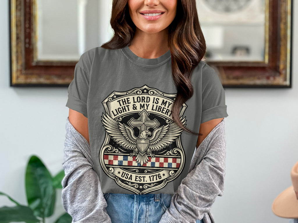 Gray t-shirt with "The Lord is my Light & Liberty" and USA 1776 badge.