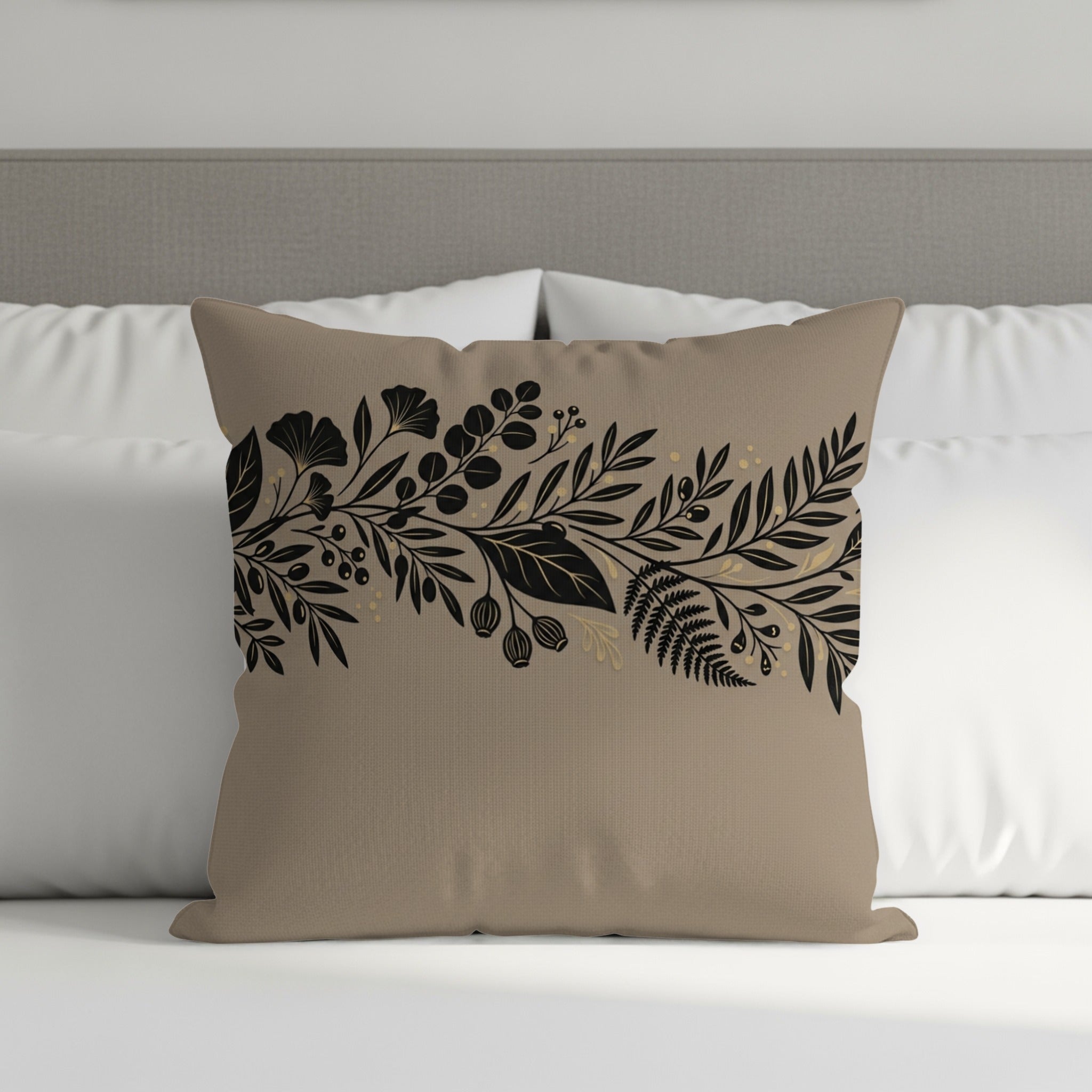 Tan throw pillow with black floral and botanical border design.