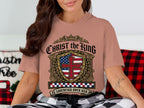 Christ the King t-shirt with a shield design featuring US flag and cross.