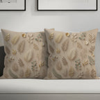 Two neutral-toned throw pillows with a botanical leaf pattern.