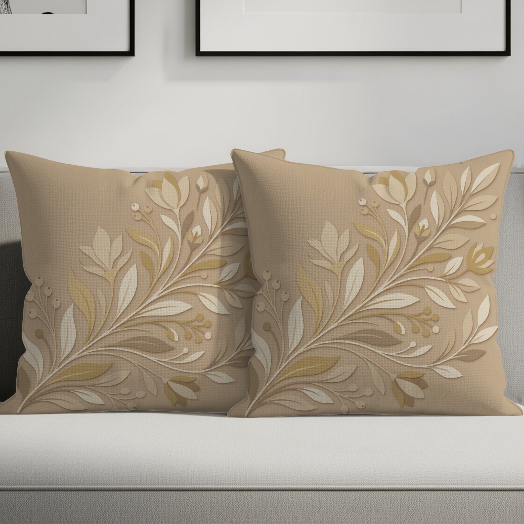 Two tan decorative pillows with cream and gold floral branch pattern.