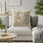Pillow with a botanical leaf pattern in earthy tones on a sofa.