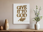 Golden 3D text "GIVE IT TO GOD" with a cross and olive branch on canvas.
