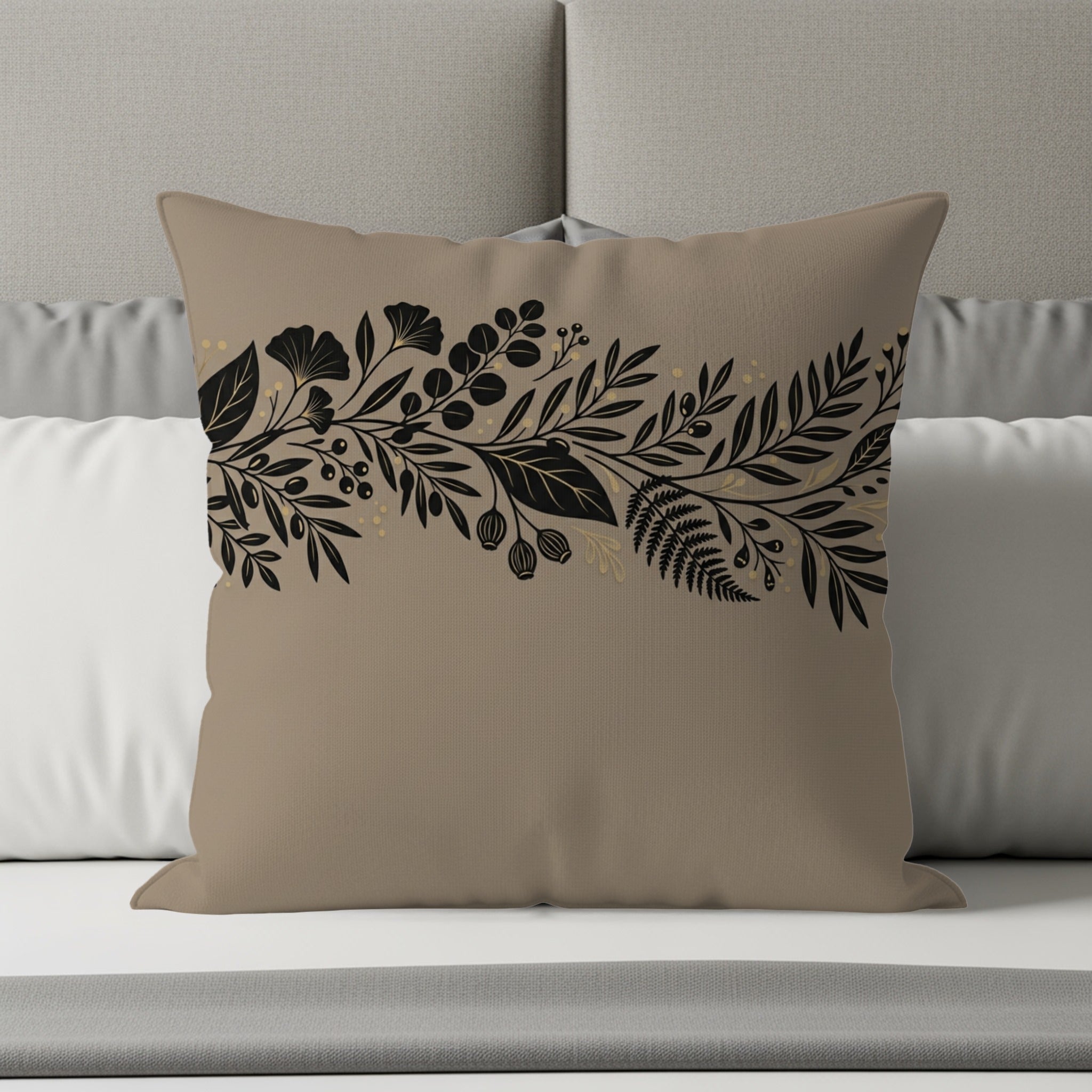 Tan throw pillow with a black and gold botanical floral border design.