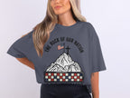 T-shirt with American flag, cross, and "The Rock of Our Nation" text on mountain.