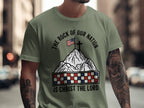 Olive t-shirt with mountain, flag, cross, and text "The Rock of Our Nation is Christ the Lord".