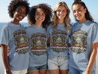 Four women wearing grey t-shirts with "Soli Deo Gloria USA EST. 1776" text.