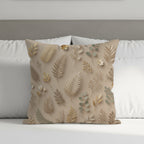 Beige throw pillow with botanical leaf pattern on a bed.