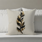Decorative pillow with a black and gold leaf design on a textured background.