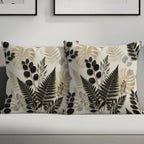 Two decorative pillows with botanical leaf patterns on a sofa.