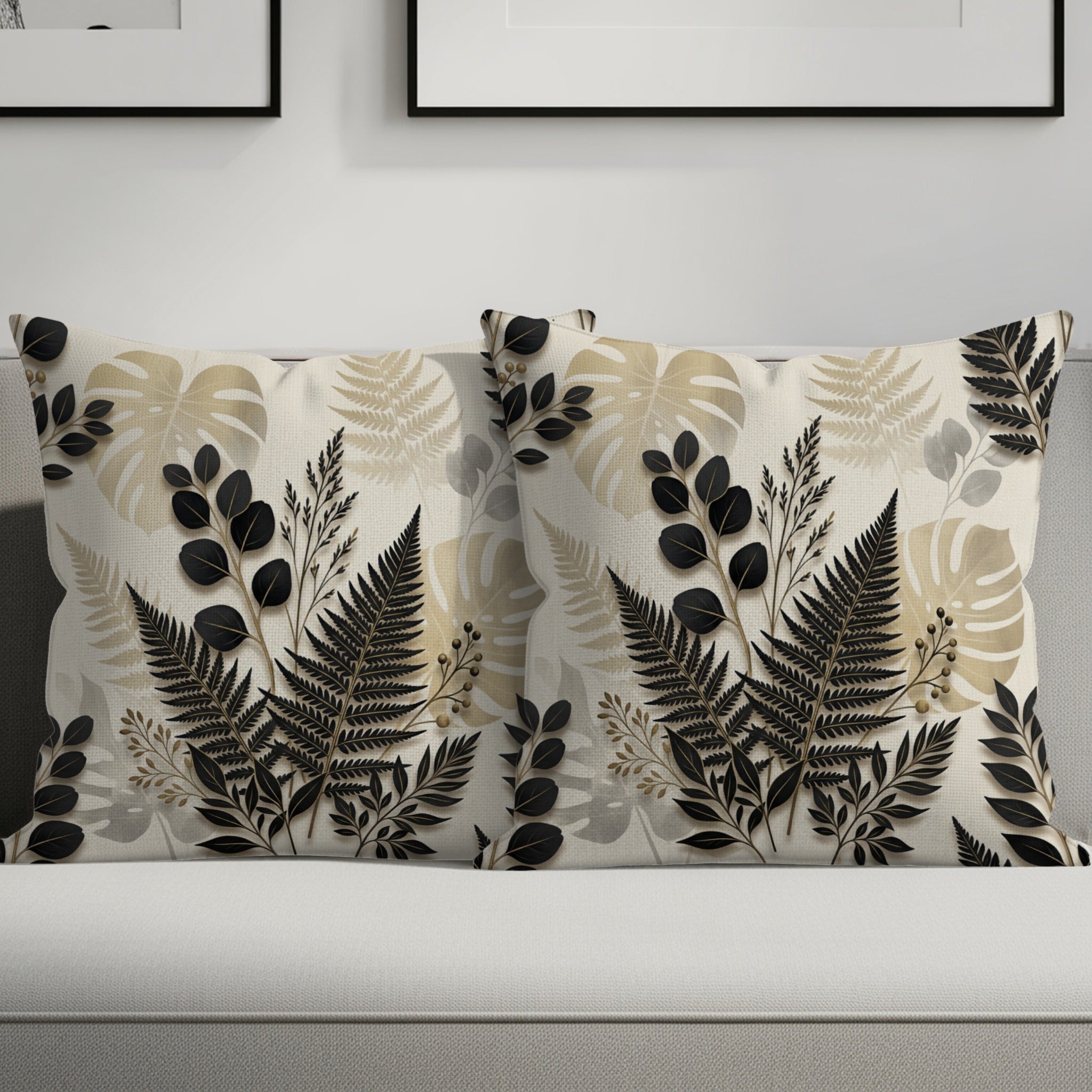 Two decorative pillows with botanical leaf patterns on a sofa.