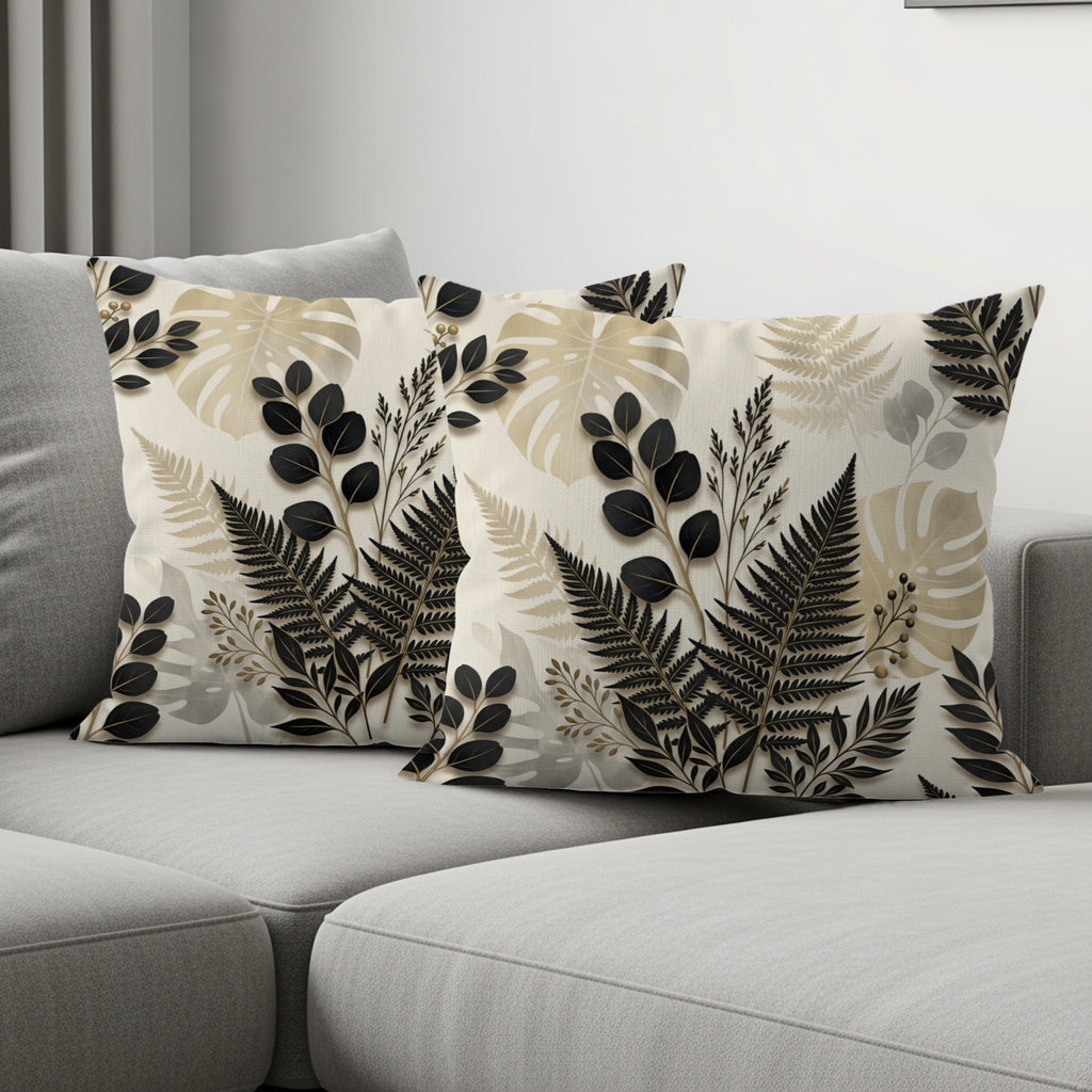 Two throw pillows with a botanical print on a gray sofa.
