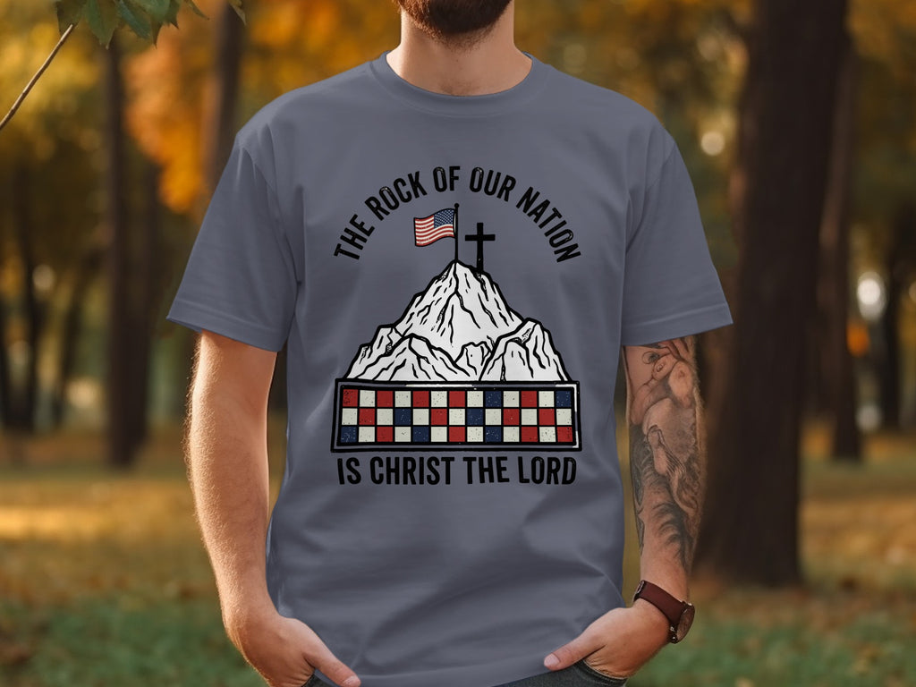 Gray t-shirt with "The Rock of Our Nation Is Christ the Lord" text and US flag on mountain.