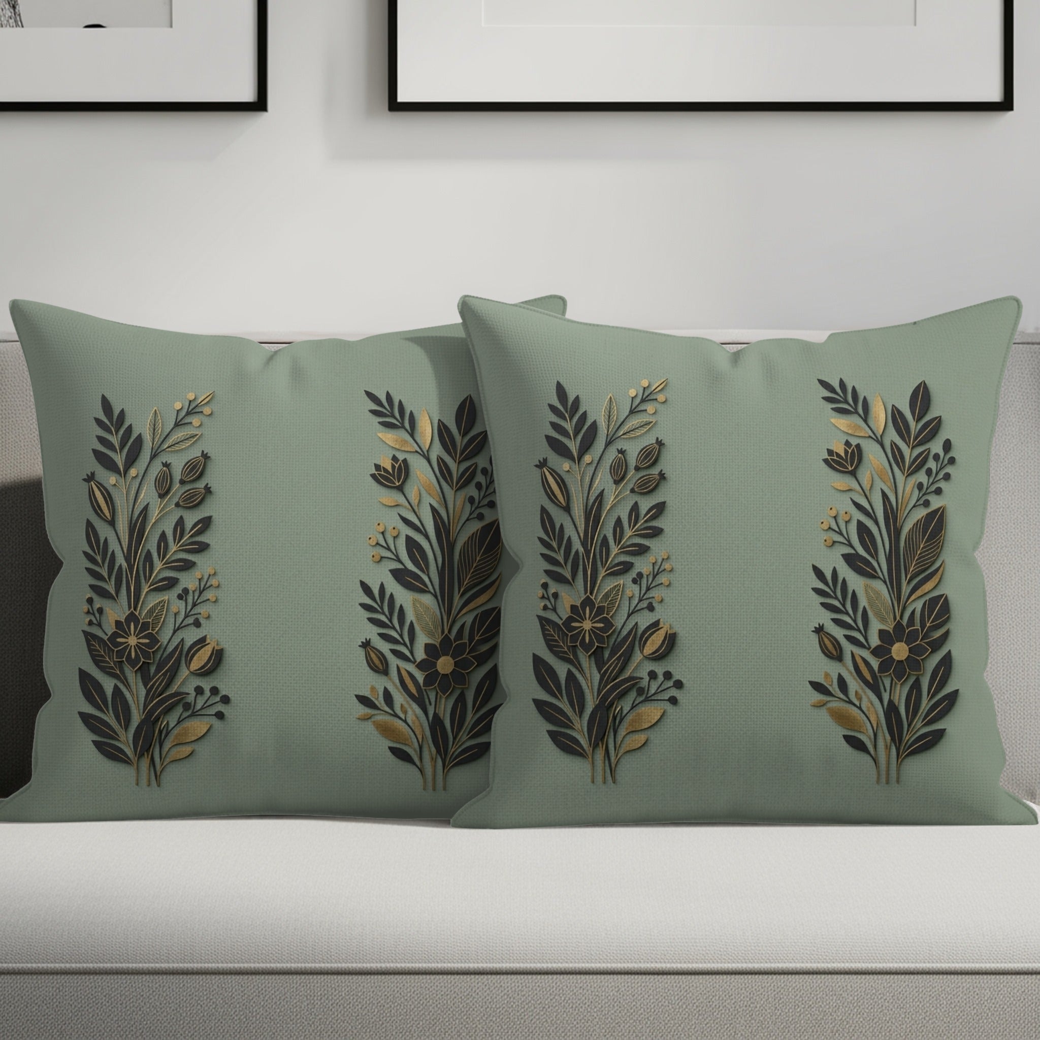 Two sage green throw pillows with botanical gold and black design.