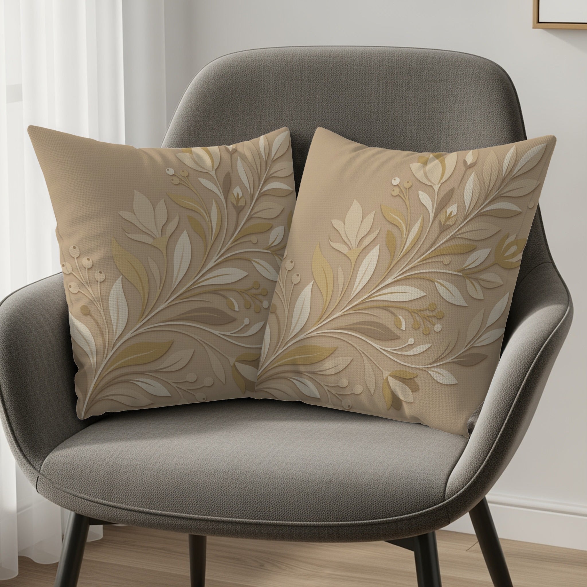 Two beige decorative pillows with a raised floral pattern on a gray armchair.