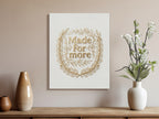 Gold laurel wreath framing "Made For More" text on canvas.