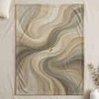 Swirling abstract pattern in beige, gray, and gold with a plus sign.