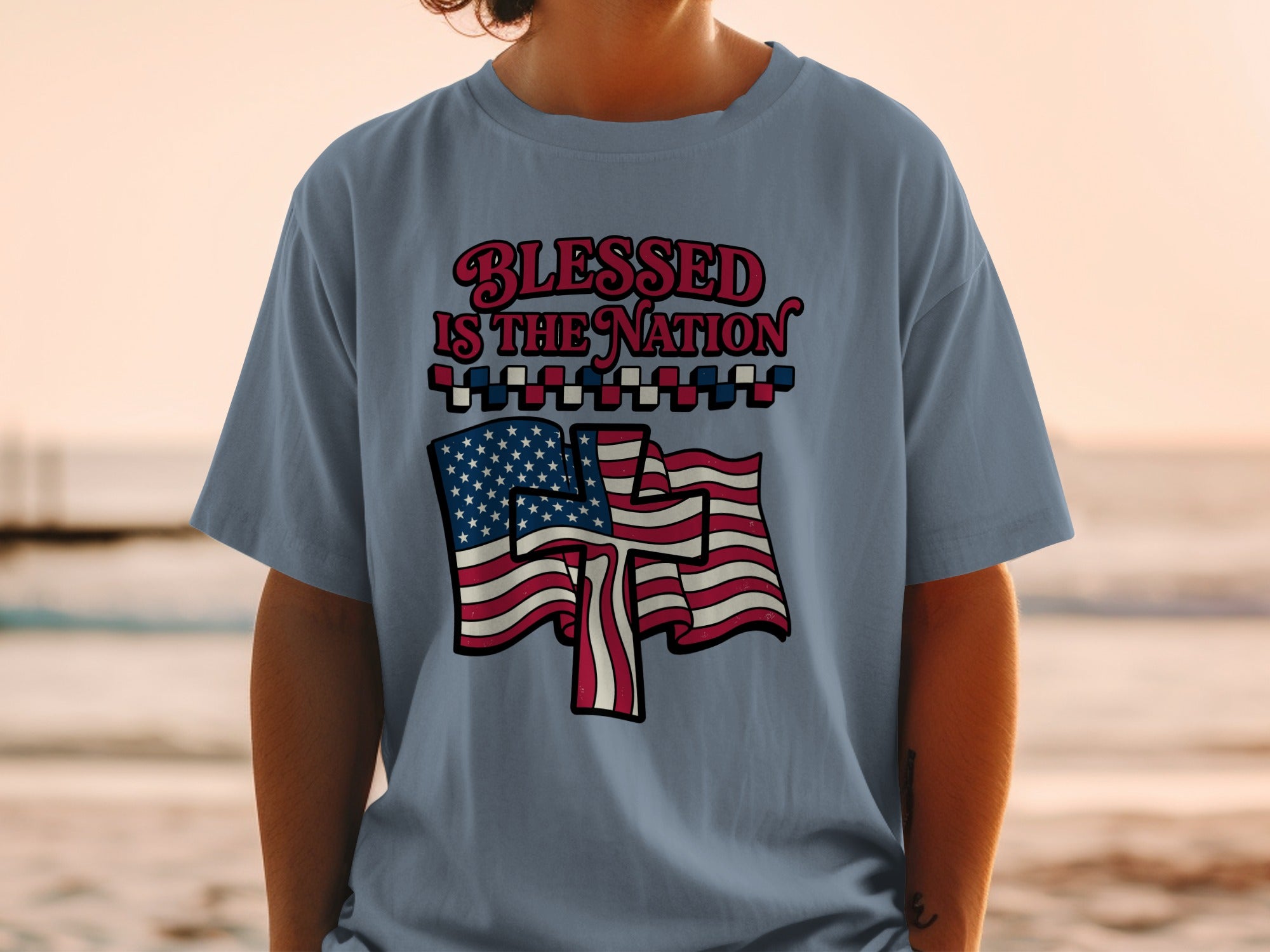 T-shirt with "Blessed is the Nation" text and American flag graphics.