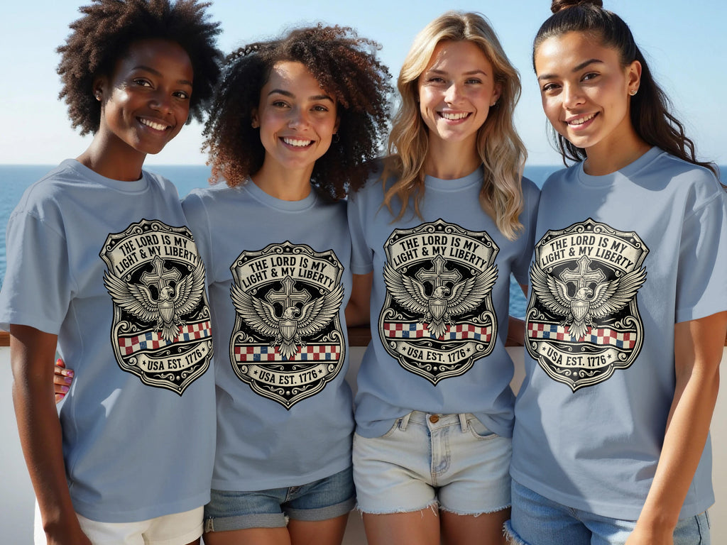 Four women model light blue t-shirts with a shield, wings, and "USA EST. 1776" text.