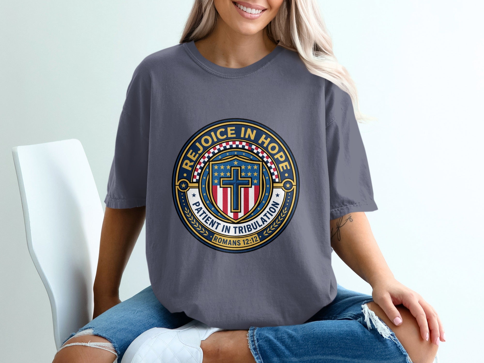 Dark grey t-shirt with circular "Rejoice in Hope" emblem featuring a cross.